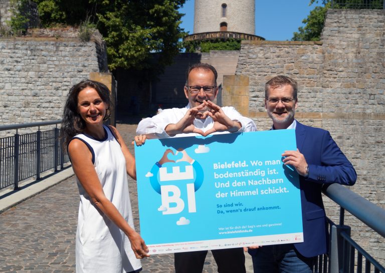 Kati Bölefahr, Martin Knabenreich und Jens Siekmann (v. l.) präsentieren die neue Kampagne. Die Plakatmotive führen zur Website, die zum Mitmachen einlädt. (Foto: Bielefeld Marketing)