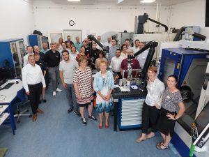 Freuen sich auf die Zusammenarbeit im Projekt: Vertreterinnen und Vertreter der zwölf Partnerorganisationen in der Lehrwerkstatt des Richard-von-Weizsäcker-Berufskollegs in Paderborn. (Foto: OWL GmbH)