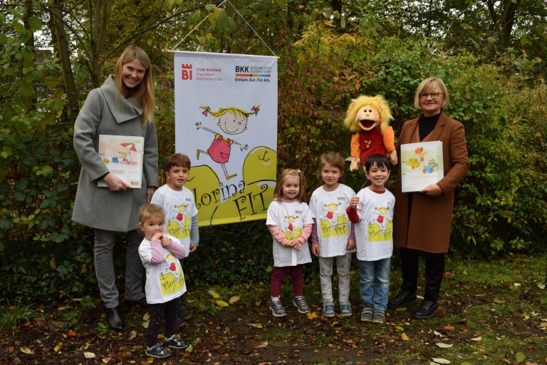 v.l: Verena Großeschallau (Projektleitung BKK GILDEMEISTER SEIDENSTICKER), Alina, Liam, Liana, Lara, Robin und Sabine Schwalbe (Leitung KiTa Kupferhammer) gratulieren Handpuppe Florina zum 15. Geburtstag.(Foto: BKK GILDEMEISTER SEIDENSTICKER)