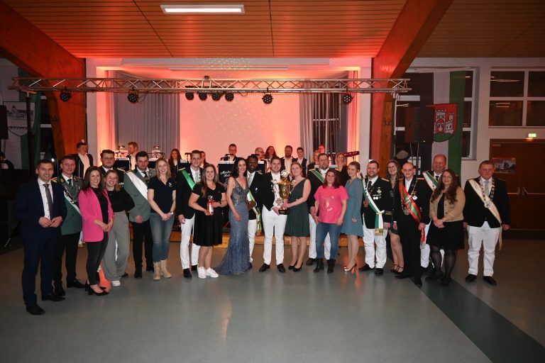 Der neue Stadtkönig Janik Stork hält zusammen mit seiner Königin Franzi Sallen stolz den Pokal in den Händen und lässt sich von Bürgermeister Burkhard Schwuchow (links) und den amtierenden Königspaaren der Ortschaften aus dem Stadtgebiet Büren feiern. (Foto: Stadt Büren)