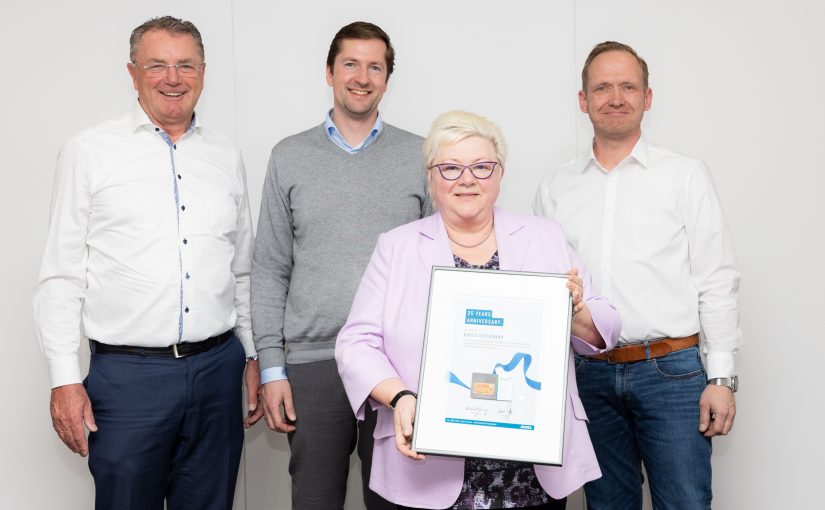 Gratulationen von allen Seiten: Die Jubilarin Birgit Ostermann mit Firmengründer Helmut Dennig sowie Abteilungsleiter Philipp Bruelheide und Teamleiter Tim Lohmeier (v.l.n.r.) (Foto: Denios)