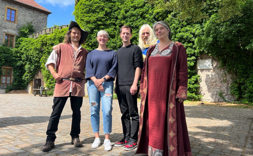 Der Tross der „Fogelvreien“ hält Einzug auf der Sparrenburg: Till Howe (l.), Johannes Faget (r.) und Elke Osterhaus (r.) von „Fogelvrei“ stellen gemeinsam mit Katharina Schilberg und Jens Kramer das Programm zum Sparrenburgfest 2023 vor. (Foto: Bielefeld Marketing GmbH)