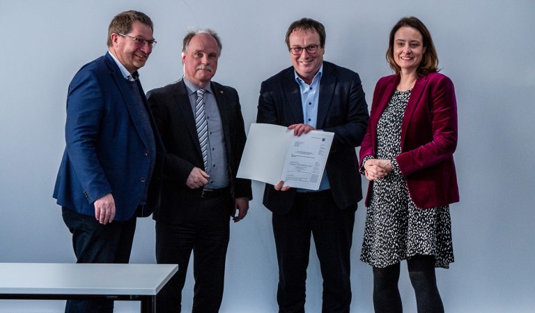 Von links: Professor Dr. Stefan Witte, Vizepräsident für Forschung und Transfer, sowie Professor Dr. Thomas Schulte, Dekan des Fachbereichs Elektrotechnik und Technische Informatik, nahmen die Förderzusage für die Campusbahn von NRW-Verkehrsminister Oliver Krischer dankend entgegen. Anna Katharina Bölling, Regierungspräsidentin im Regierungsbezirk Detmold, hatte die Papiere mitgebracht. (Foto: TH OWL)