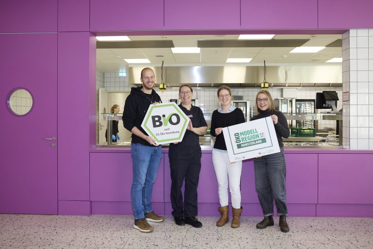 Freuen sich darüber, dass ab sofort täglich mehr als 1000 Essen aus regionalen Lebensmitteln für die Schülerinnen und Schüler zur Verfügung stehen (v.l.): Stephan Häming (Vorstand Mensaverein), Meike Schlautmann (Küchenleitung), Juliane Rabe und Rebekka Hinckers (beide Öko-Modellregion Münsterland). (Foto: Münsterland e.V./Philipp Fölting)