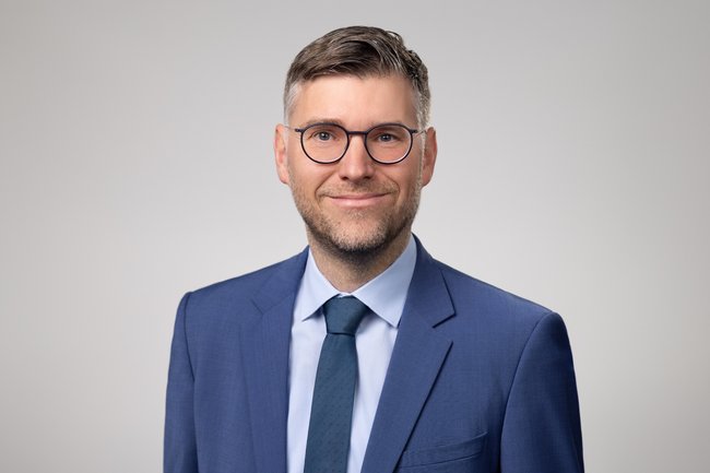 Portrait von Dr. Johannes Gernandt, Chefvolkswirt des VDMA im Anzug und mit Brille