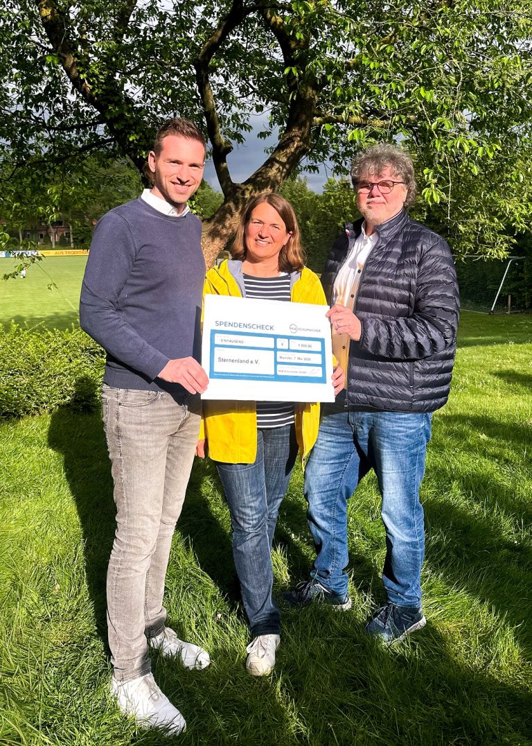 Lennart Brüggemann und Kirsten Herchen von HLB Schumacher überreichen Joachim Dorus vom Verein Sternenland einen Spendenscheck