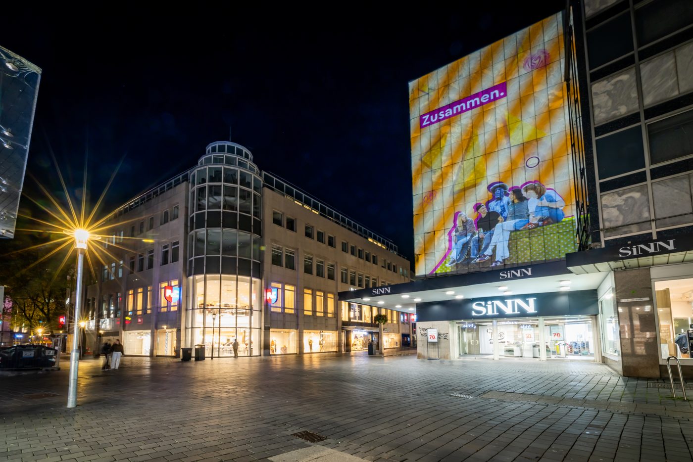 Lichtprojektion mit Bielefelder Motiven auf einer Gebäudefassade in der Bahnhofstraße.
